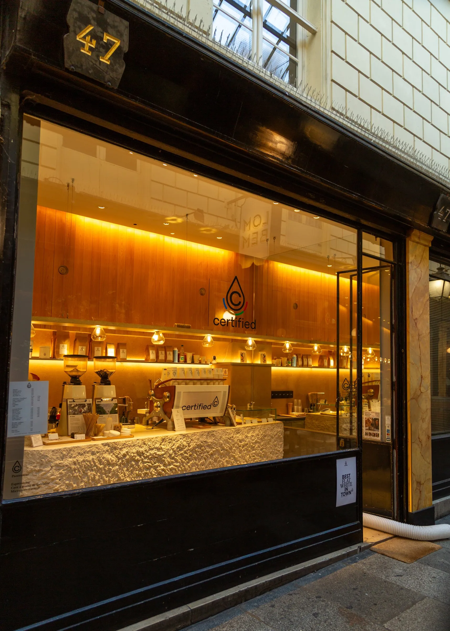A coffee bar lit up gold before the street woke up