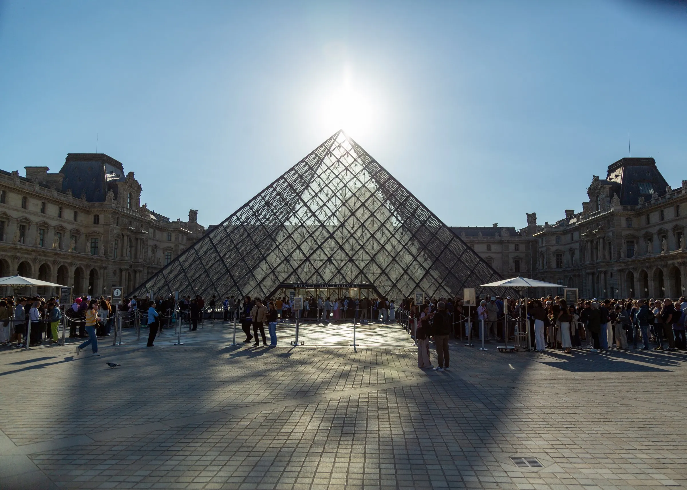 The Louvre pyramid against the sun. I walked the grounds instead of going in