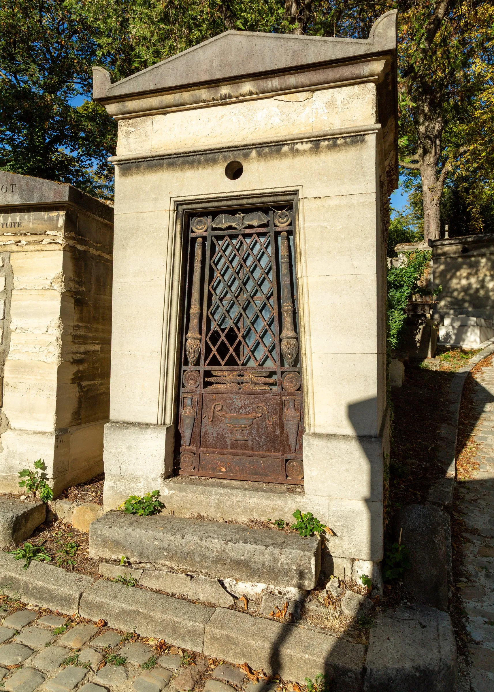 A weathered tomb door at Père-Lachaise