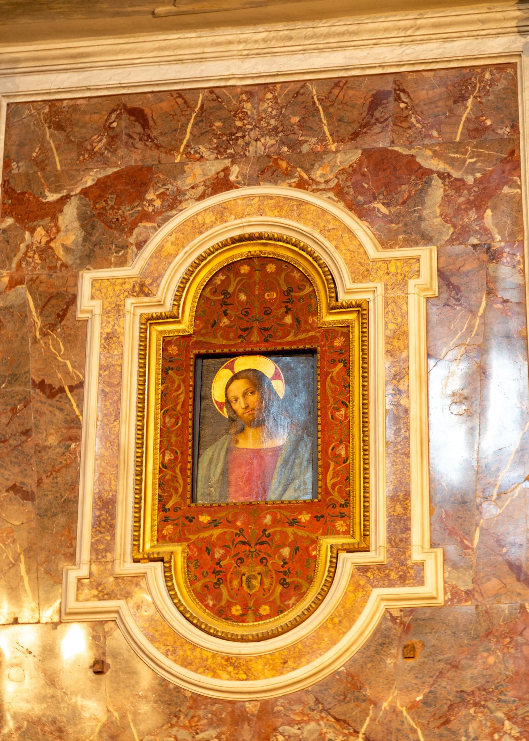 A painted Christ in a marble frame