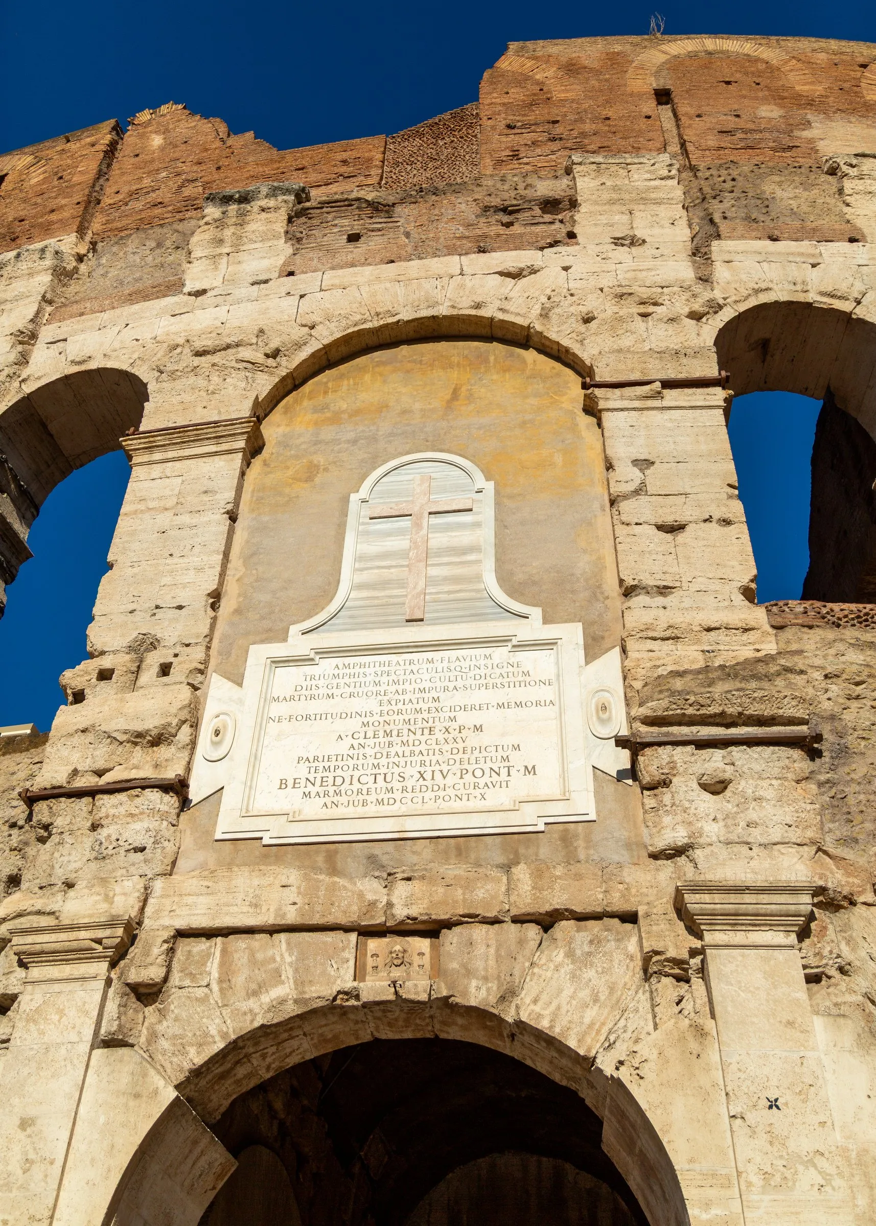 A papal inscription over a Colosseum arch