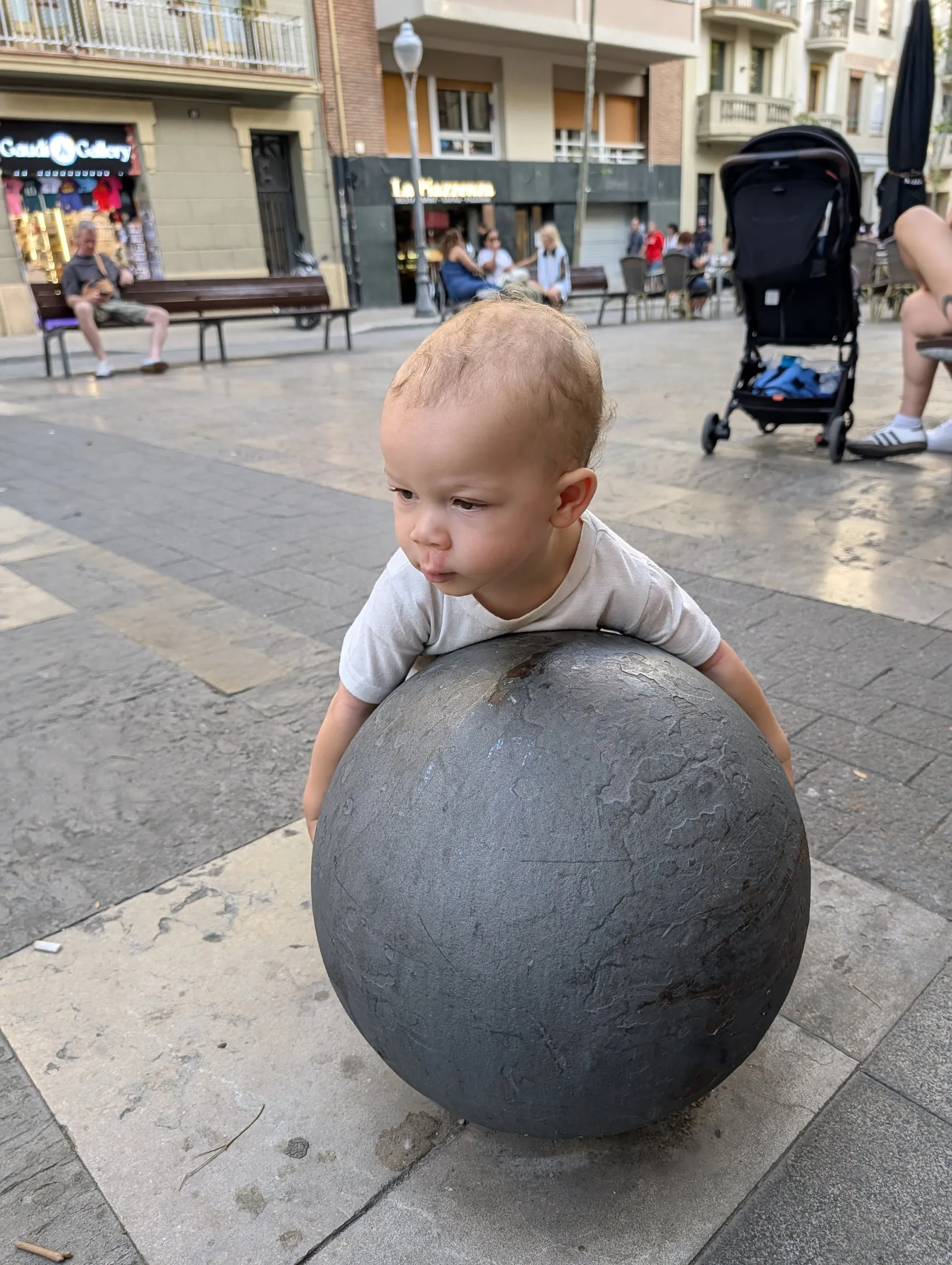 Zavier making friends with a bollard near the Sagrada Família