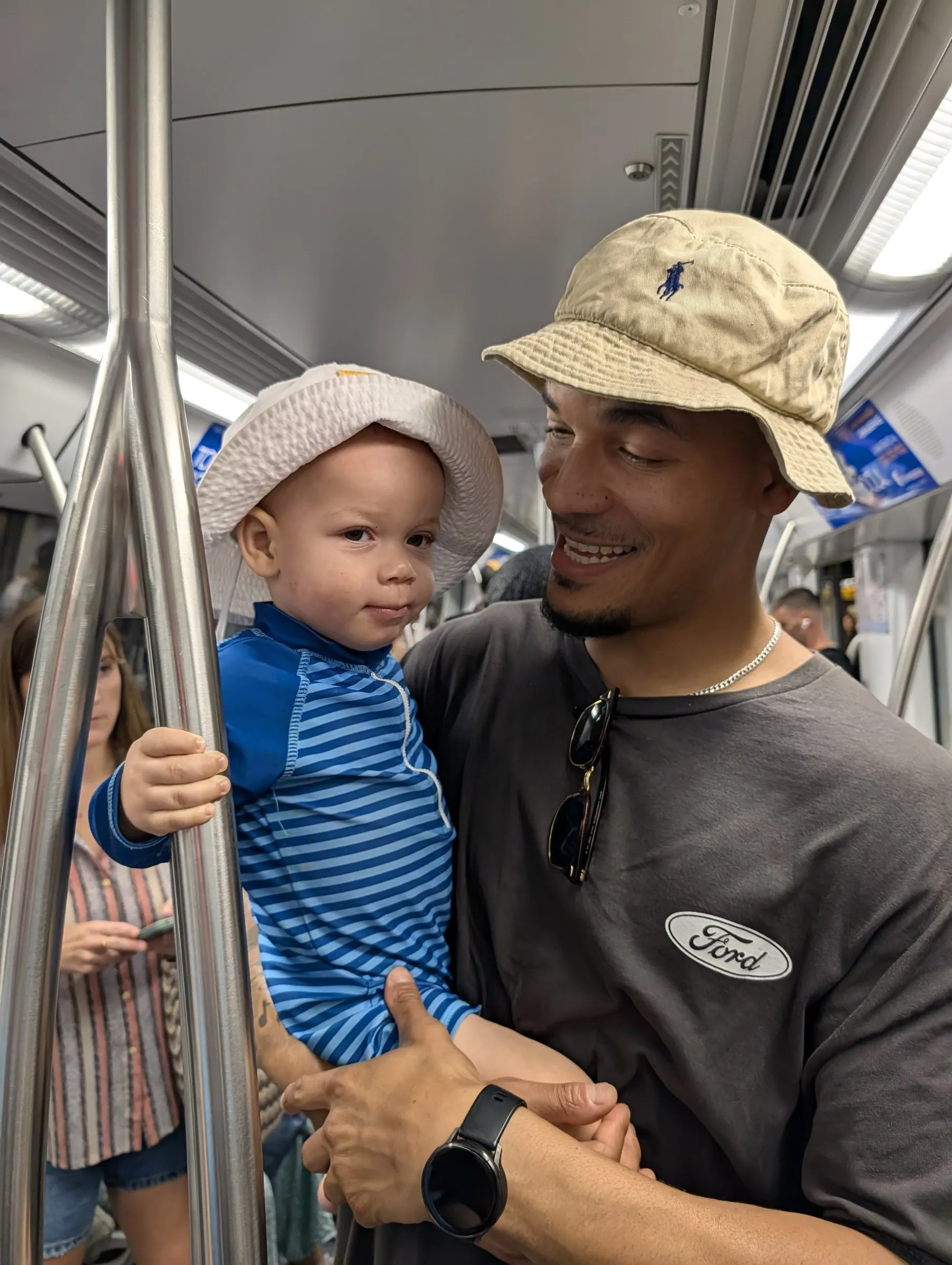 Miguel and Zavier on the metro home after the beach