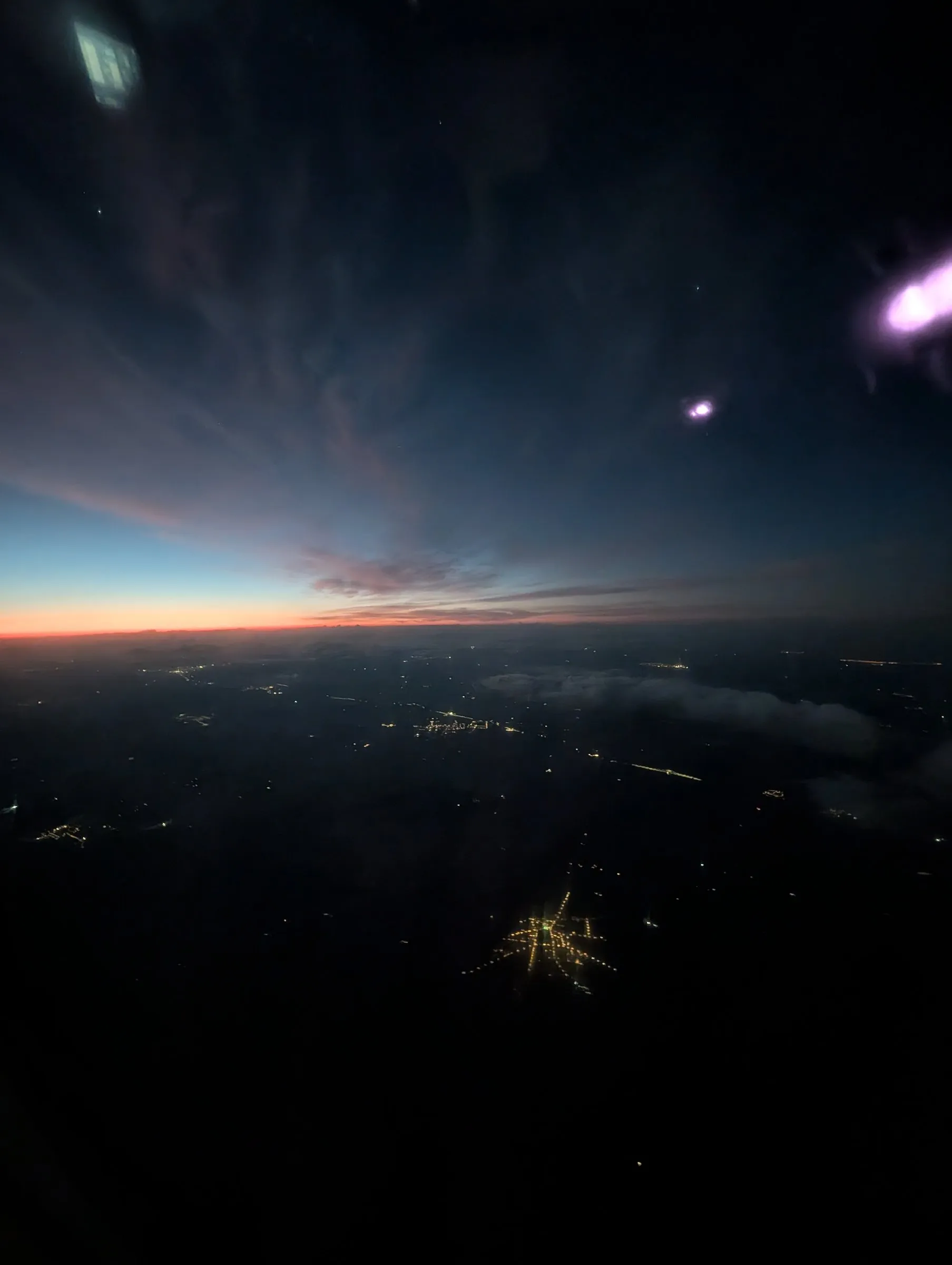 Pre-dawn takeoff over the island lights