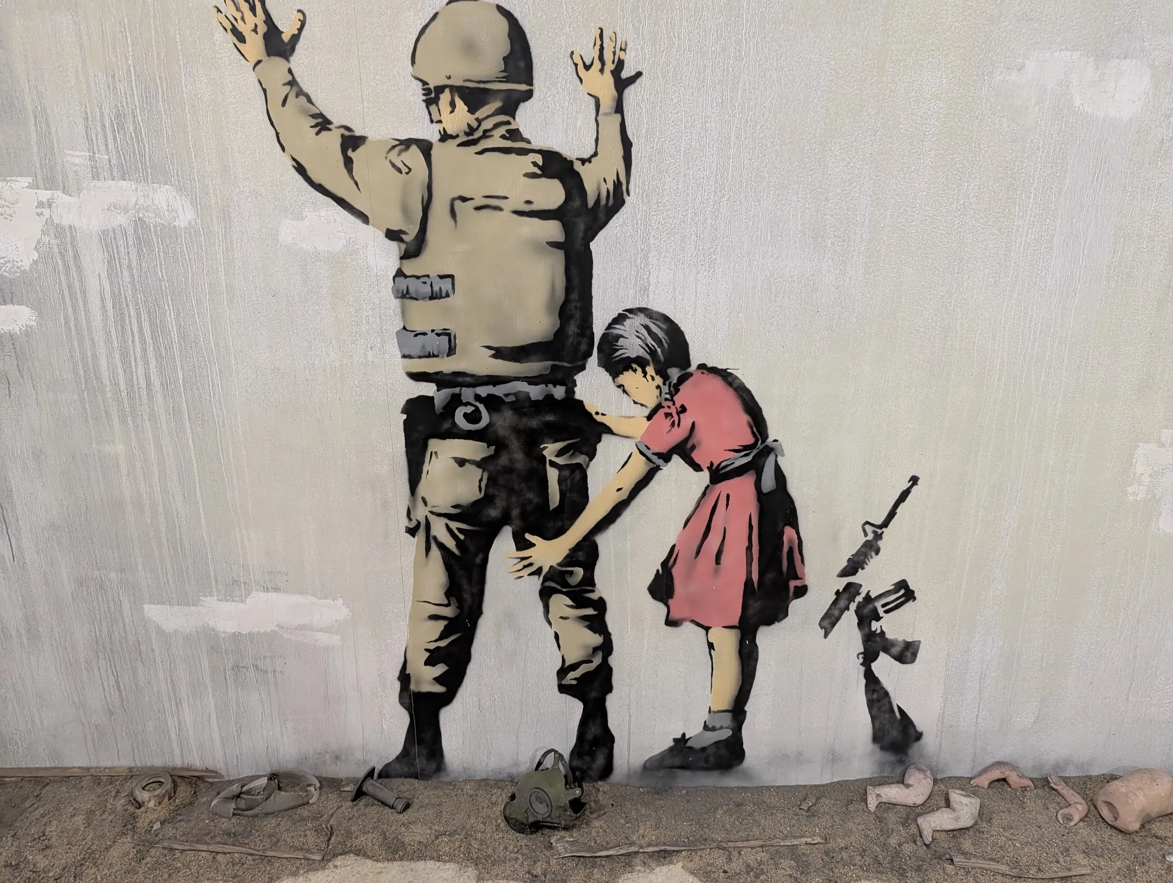 Banksy: the girl frisking the soldier