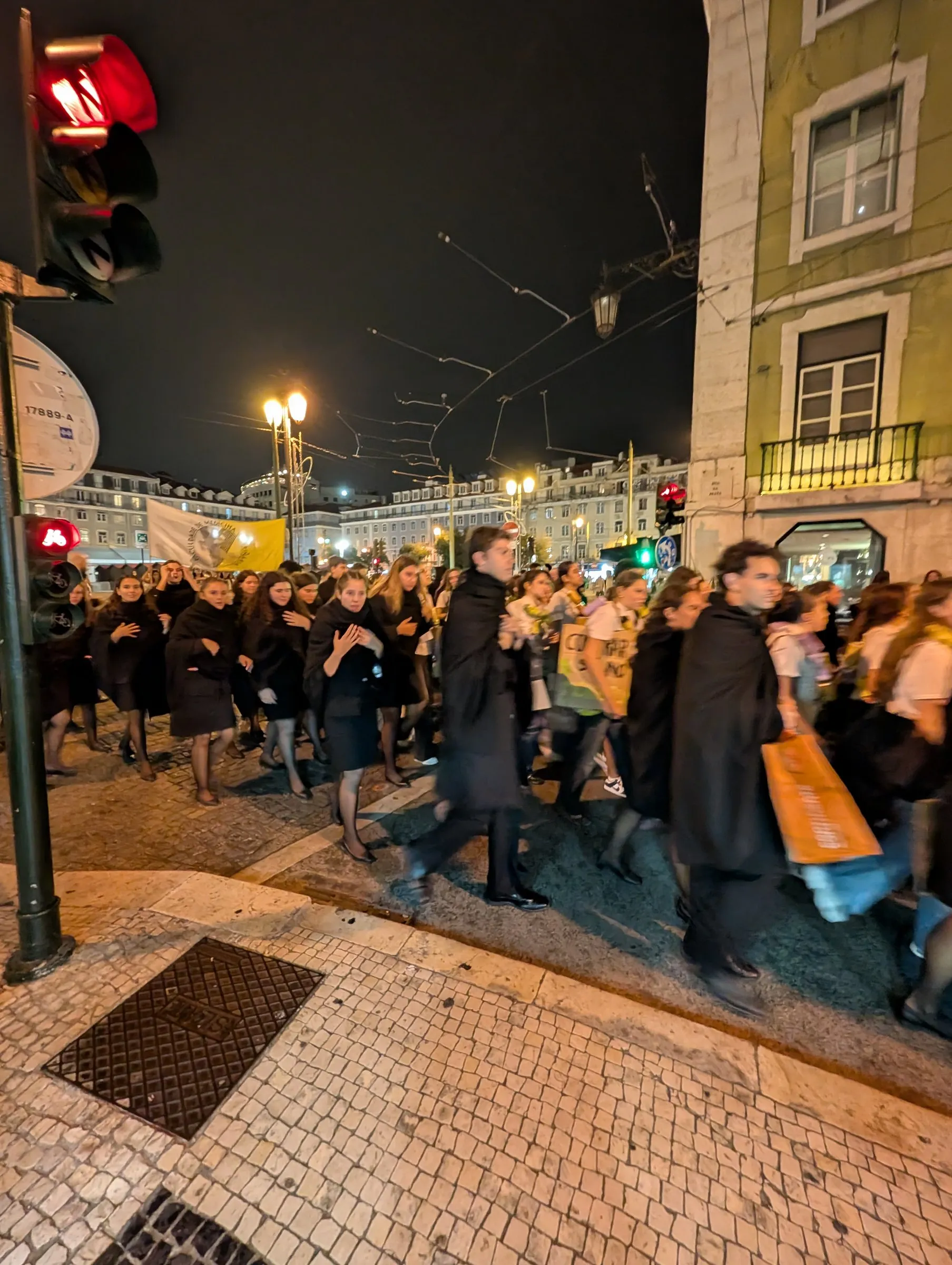 Students in academic capes parading at night