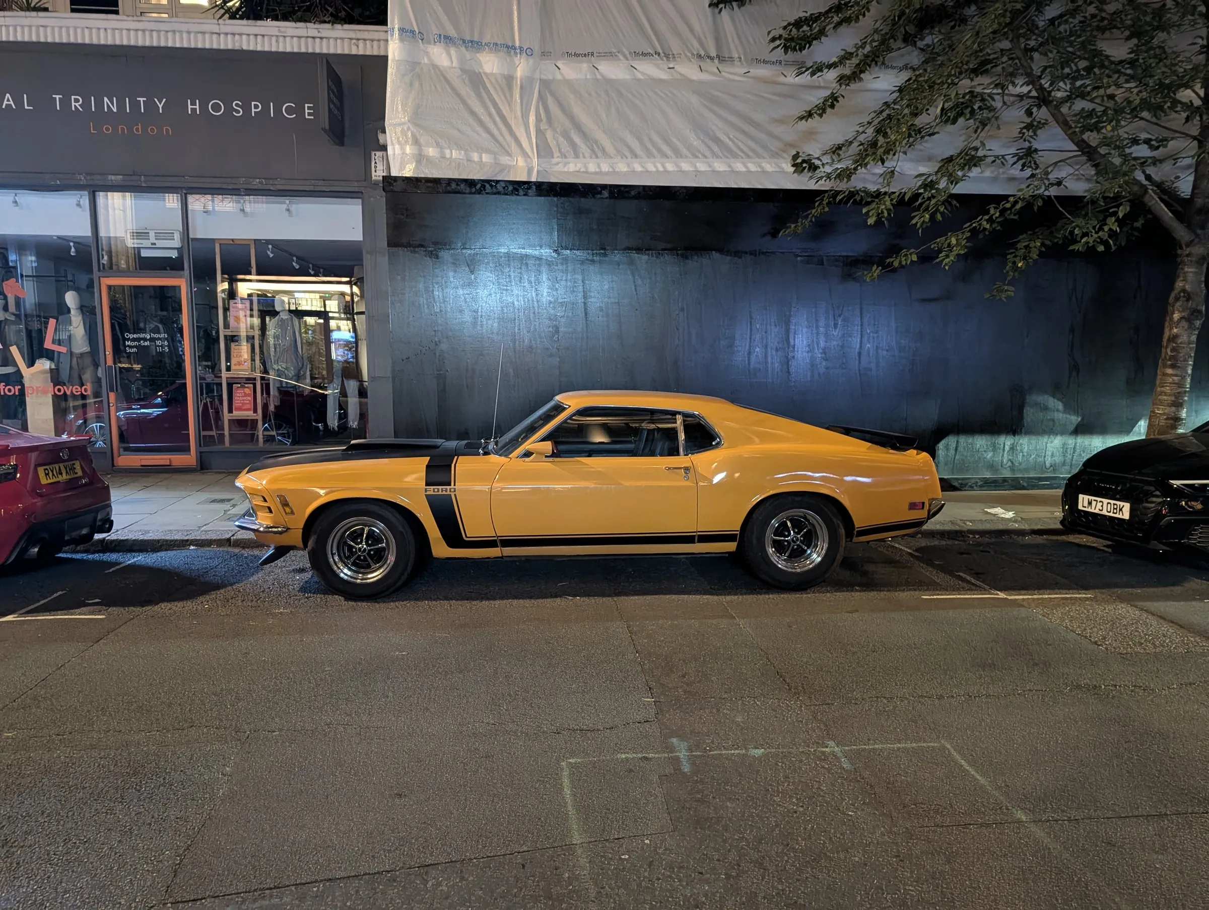 A classic Mustang parked up at night